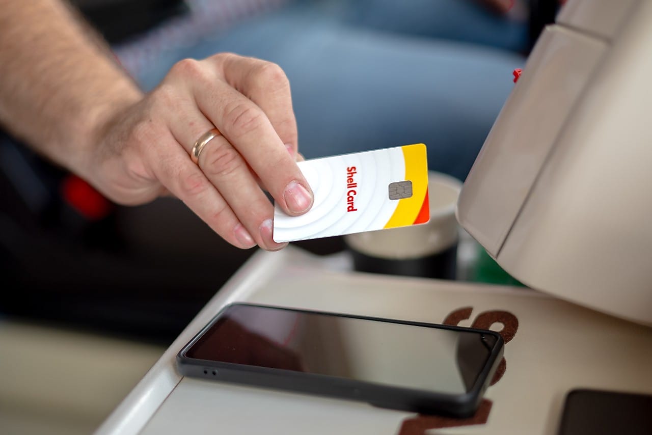 Truck driver holding a Shell card
