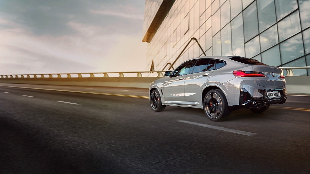 Silver BMW with man getting into it taken from above