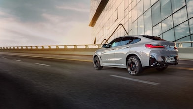 Silver BMW with man getting into it taken from above